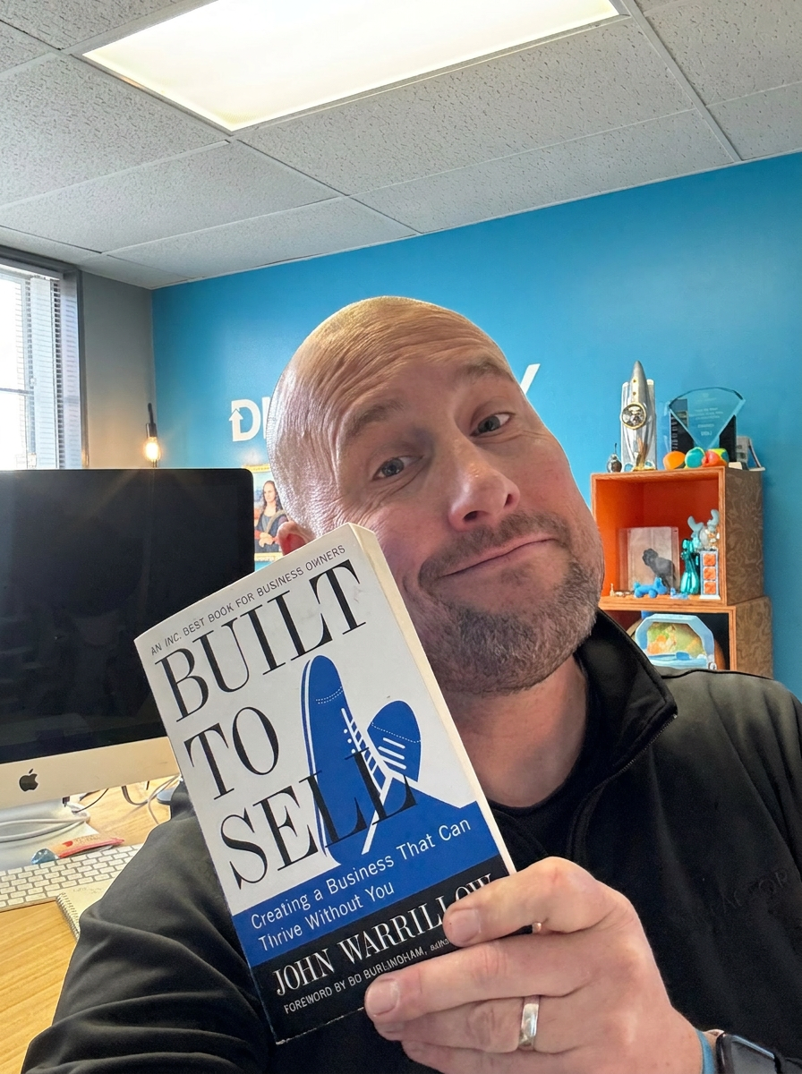 Kevin Oldham holding Built to Sell by John Warrillow