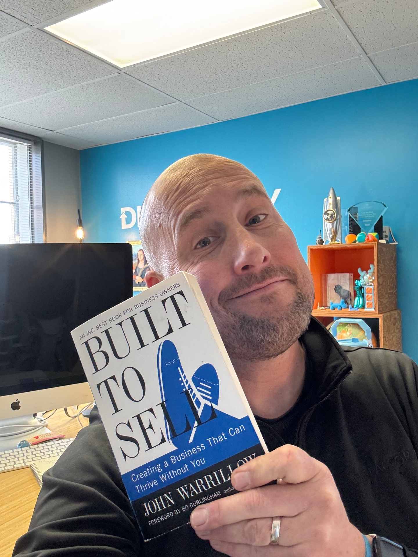 Kevin Oldham holding Built to Sell by John Warrillow